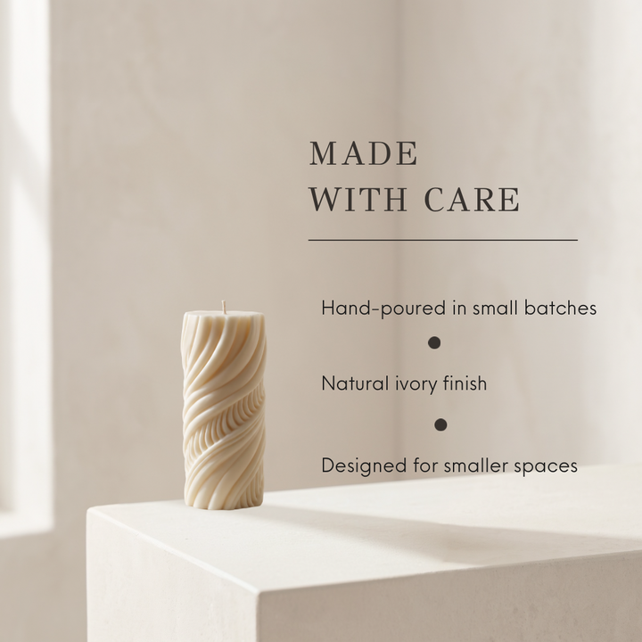 A textured cream-colored pillar candle with a twisted, ribbed design sits on a white pedestal against a warm beige background. To the right, text reads &