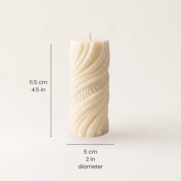 An off-white twisted pillar candle with dimension lines and text indicating a height of 11.5 cm and 5cm in diameter 