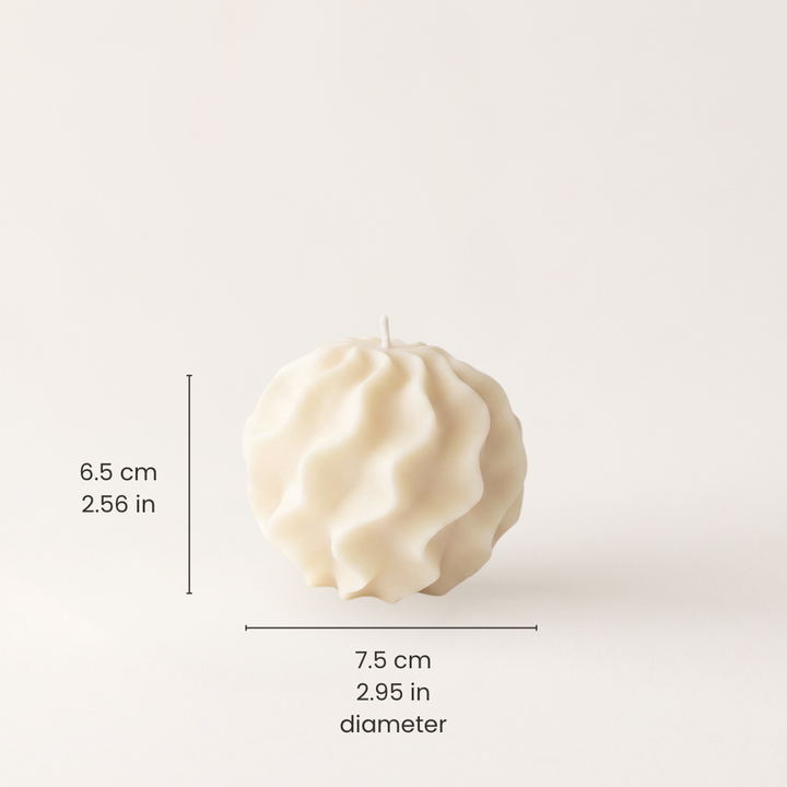An off-white, textured spherical candle with a wick on top, shown with black dimension lines and text indicating a height of 6.5 cm (2.